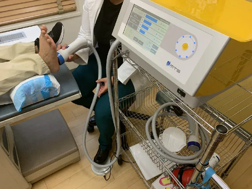 Treatment applicator used near a foot