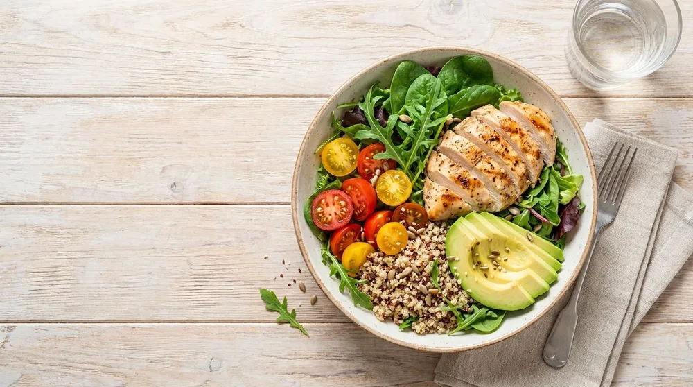 Illustrative meal with vegetables, grains and chicken